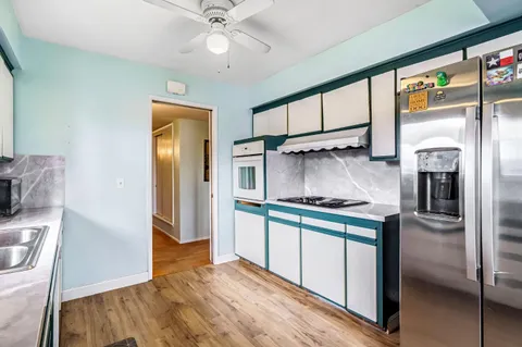 a kitchen with lots of counter space and dining table