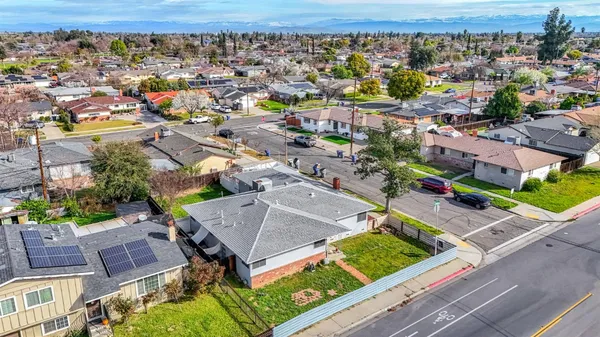 an aerial view of a house with a yard