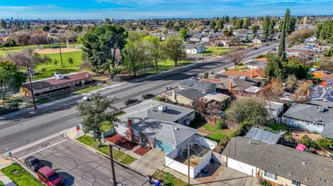 an aerial view of houses with swimming pool