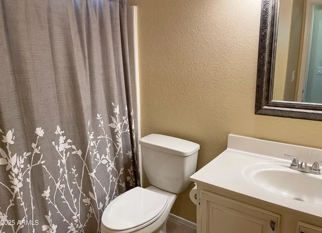 a white toilet sitting next to a bathroom sink