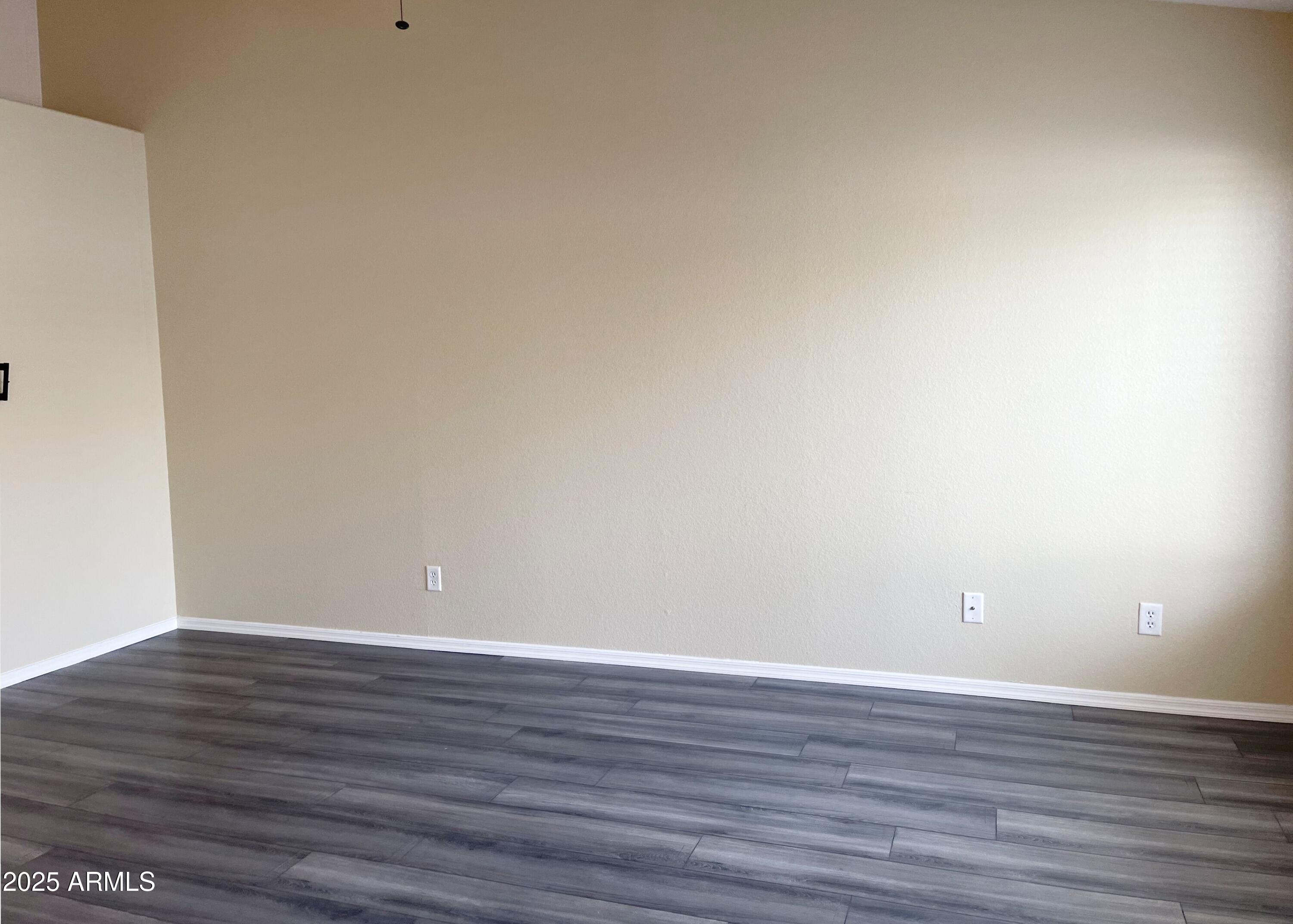 6926 West Via Del Sol Drive Glendale, AZ 85310 - Photo 4 of 18 a view of an empty room with wooden floor