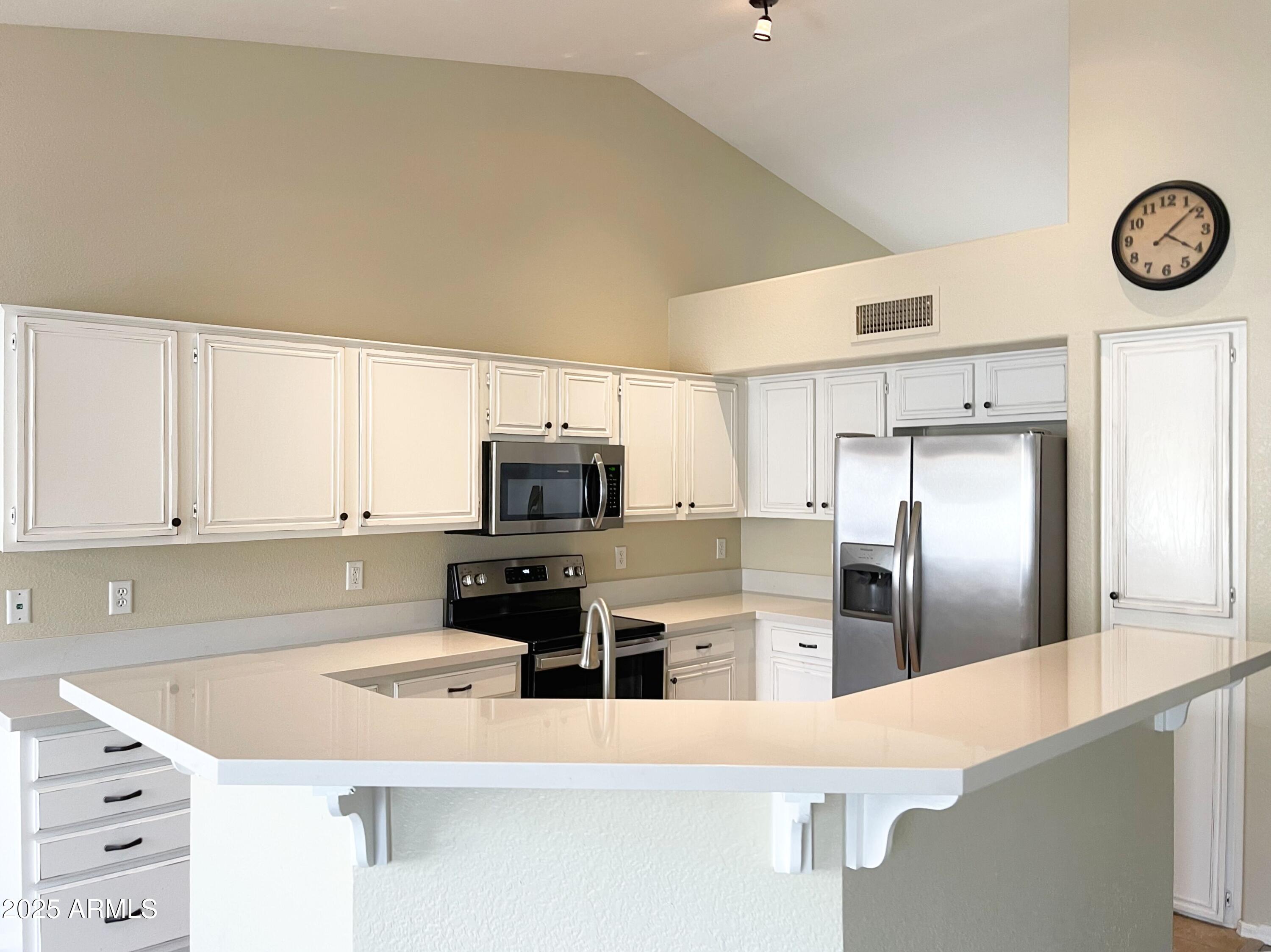 6926 West Via Del Sol Drive Glendale, AZ 85310 - Photo 5 of 18 a kitchen with cabinets and stainless steel appliances