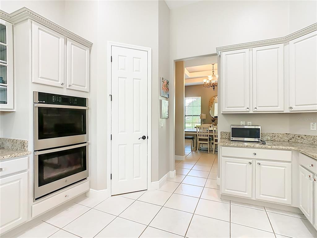 915 San Raphael Street Poinciana, FL 34759 - Photo 14 of 84 a kitchen with white cabinets and appliances