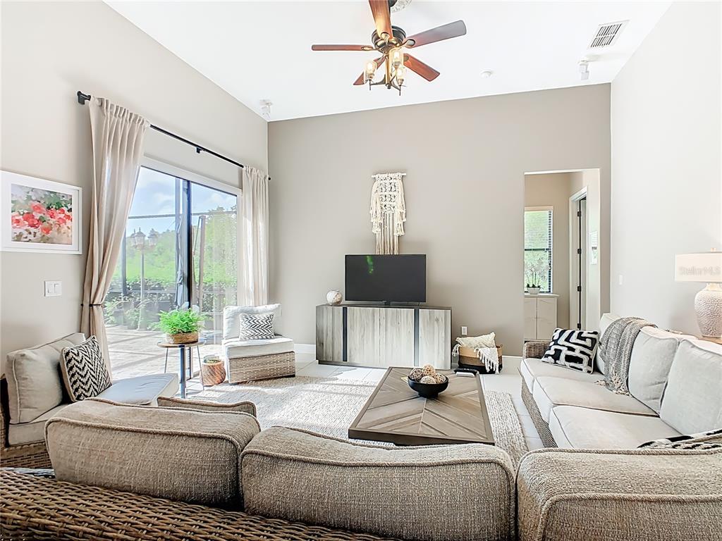 915 San Raphael Street Poinciana, FL 34759 - Photo 20 of 84 a living room with furniture and a flat screen tv