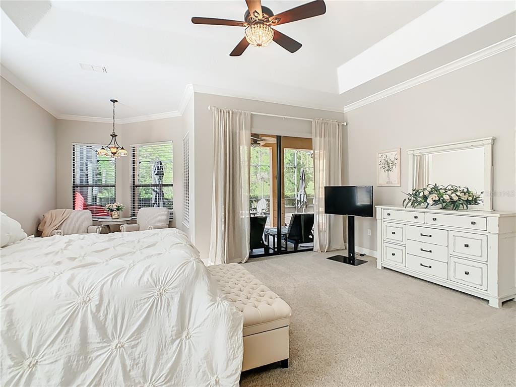 915 San Raphael Street Poinciana, FL 34759 - Photo 21 of 84 a bedroom with a bed chandelier and window