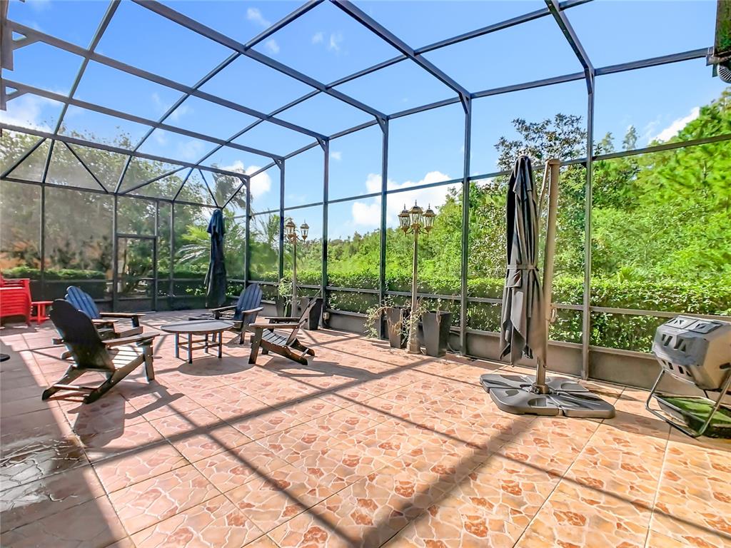 915 San Raphael Street Poinciana, FL 34759 - Photo 3 of 84 a outdoor space with the couches and dining table with the garden view