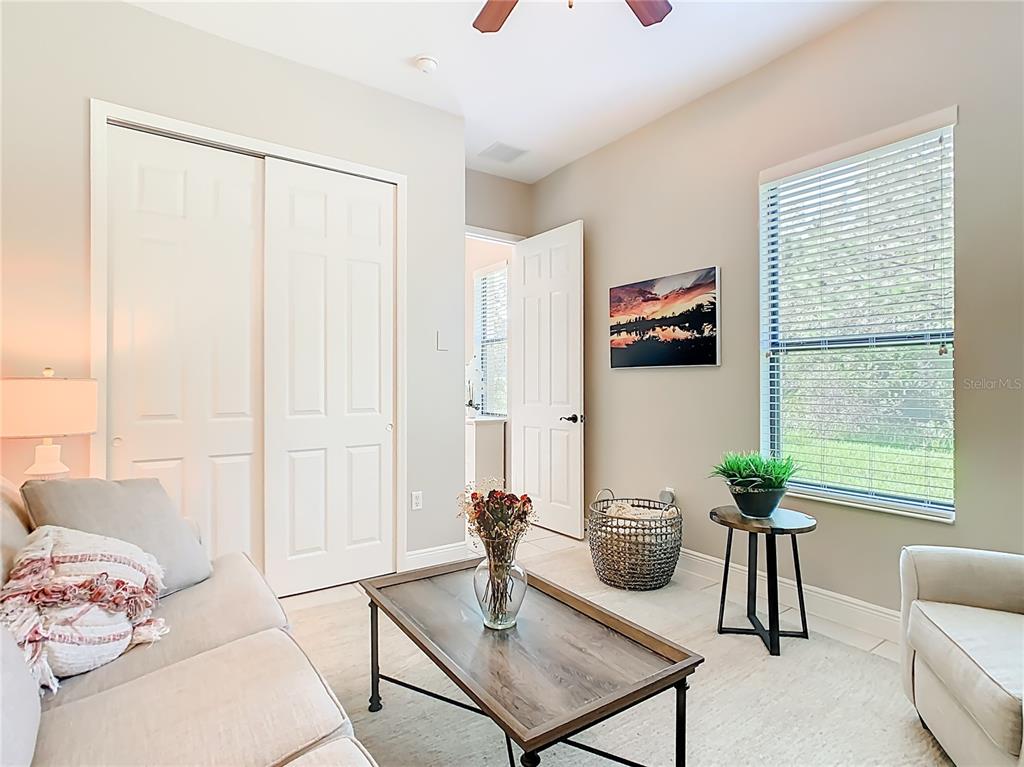 915 San Raphael Street Poinciana, FL 34759 - Photo 31 of 84 a living room with furniture and a potted plant