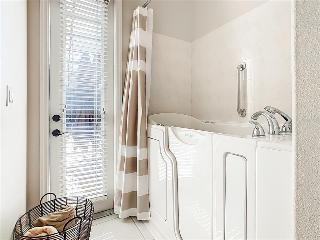 915 San Raphael Street Poinciana, FL 34759 - Photo 33 of 84 a bathroom with a bathtub sink and a mirror