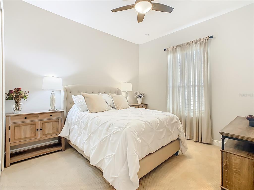 915 San Raphael Street Poinciana, FL 34759 - Photo 36 of 84 a bed room with a bed and a chandelier