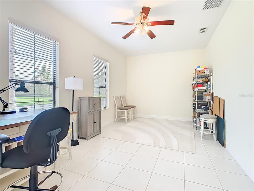 915 San Raphael Street Poinciana, FL 34759 - Photo 44 of 84 a view of a workspace with furniture and a window