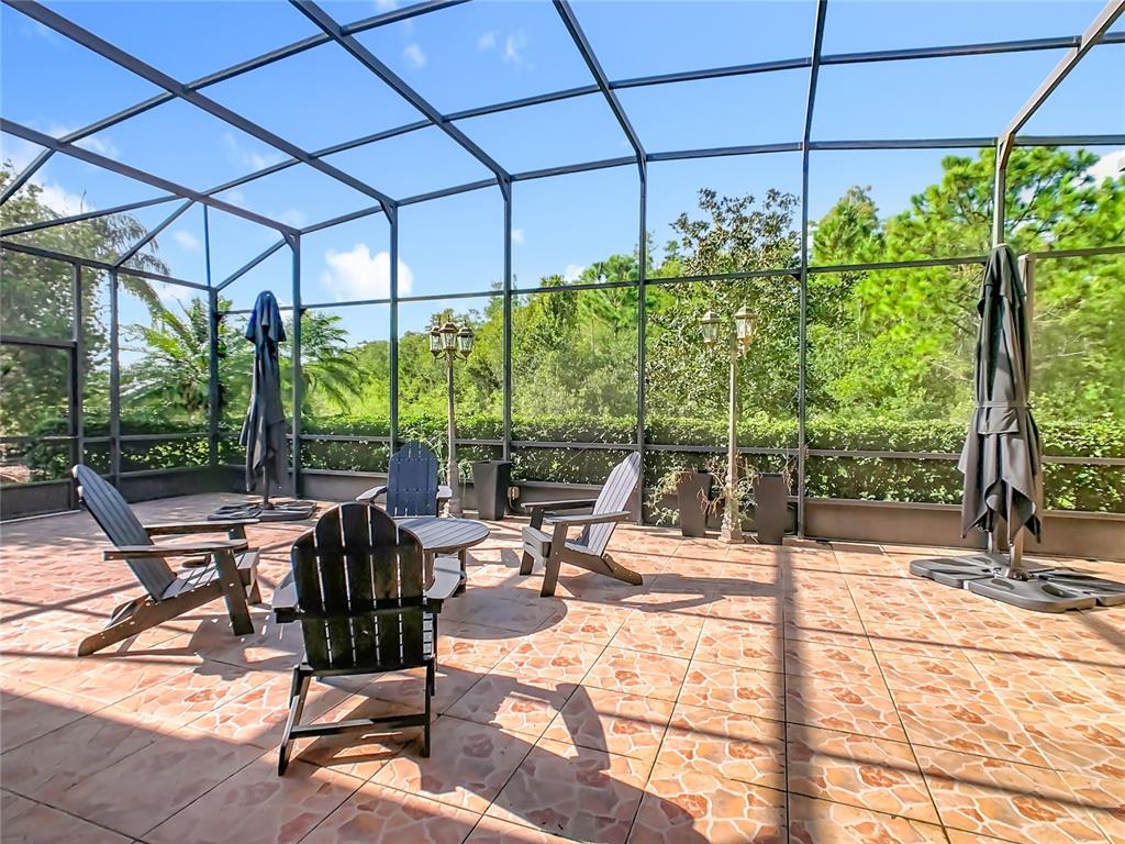 915 San Raphael Street Poinciana, FL 34759 - Photo 51 of 84 a view of a patio with table and chairs under an umbrella