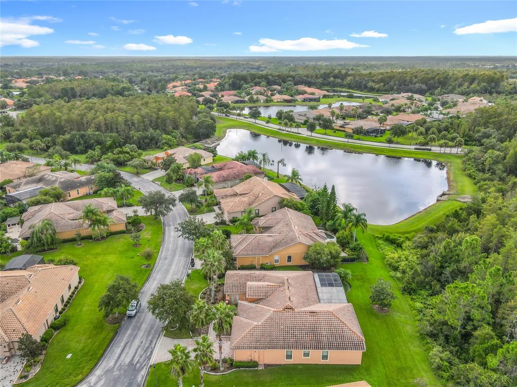 915 San Raphael Street Poinciana, FL 34759 - Photo 57 of 84 an aerial view of residential houses with outdoor space and lake view in back