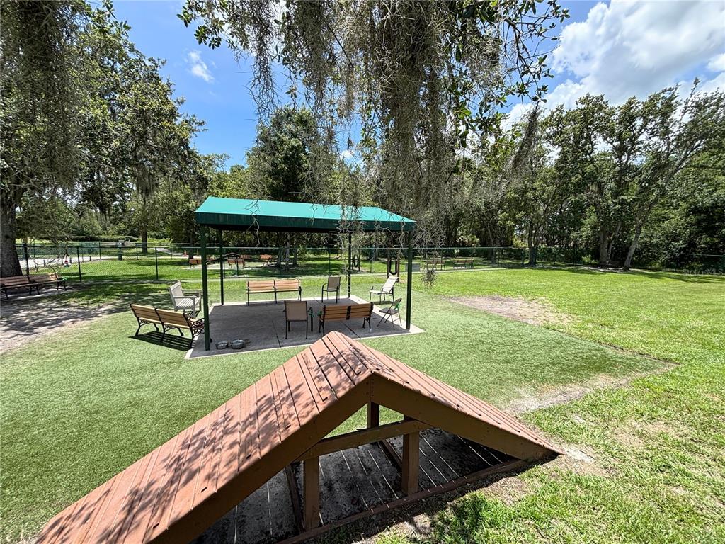 915 San Raphael Street Poinciana, FL 34759 - Photo 78 of 84 a view of a garden with a patio