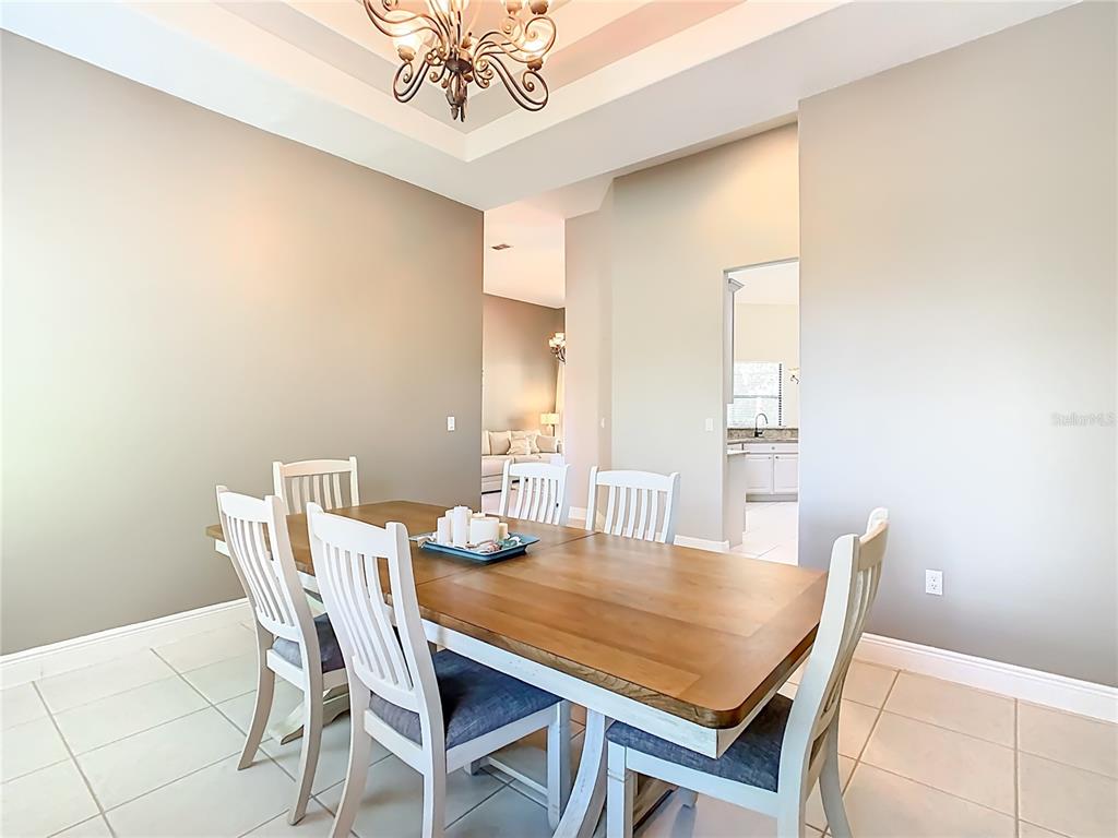 915 San Raphael Street Poinciana, FL 34759 - Photo 9 of 84 a view of a dining room with furniture and a chandelier