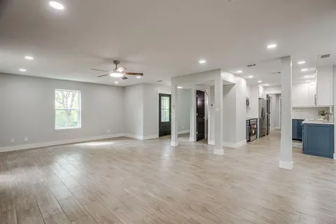 a view of a big room with windows and a chandelier