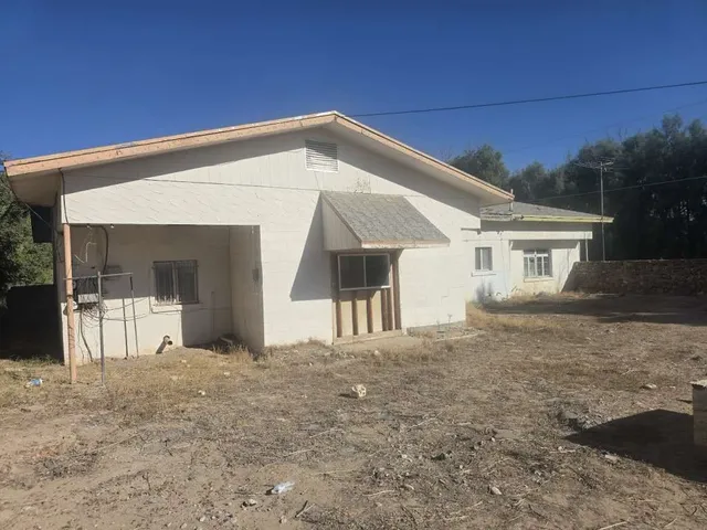 a view of a house with a backyard and balcony
