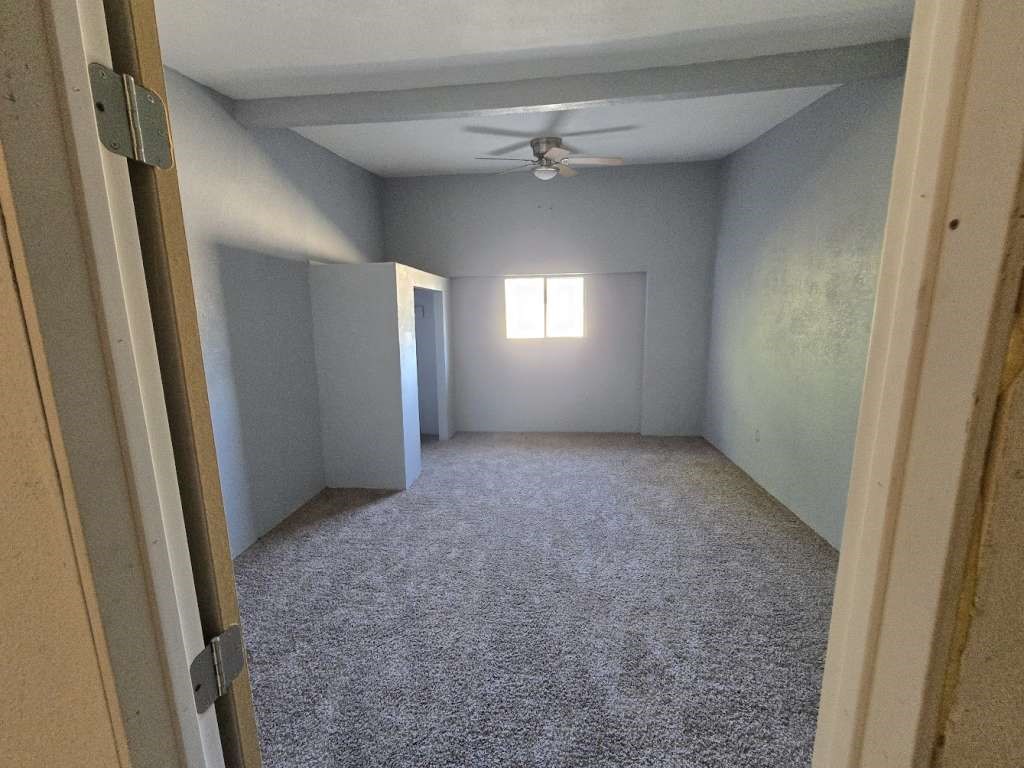 7833 Kiely Road Vinton, TX 79821 - Photo 4 of 10 an empty room with windows and fan