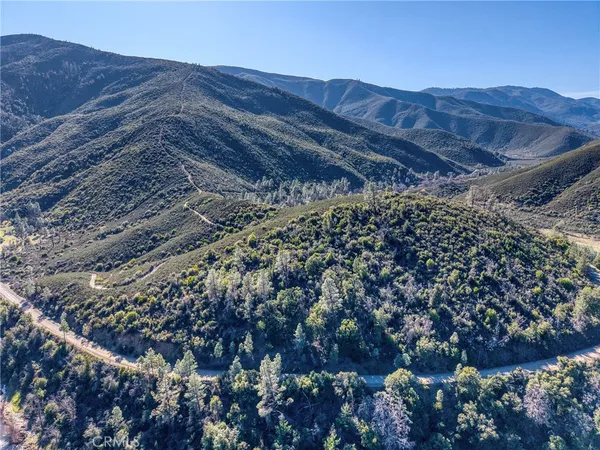 a view of a dry yard with mountains