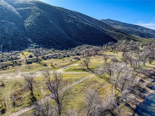 a aerial view of house with mountain view