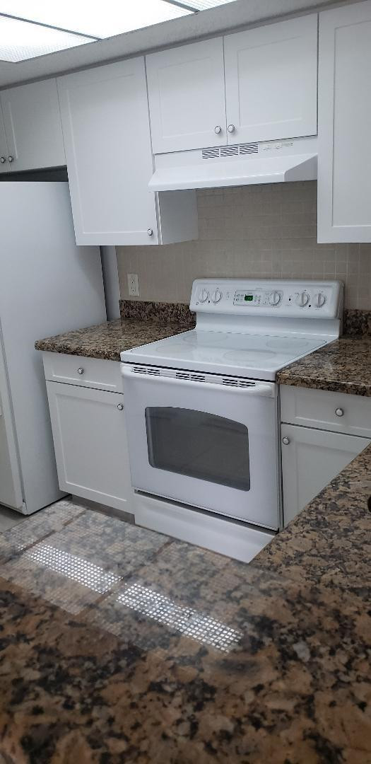5011 Wiles Road, Unit 301 Coconut Creek, FL 33073 - Photo 8 of 16 a stove top oven sitting inside of a kitchen
