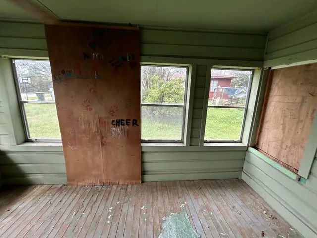 a view of front door with wooden floor and a window