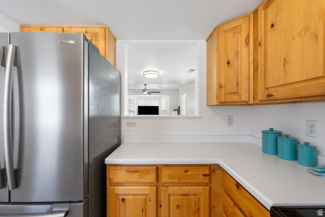 732 North 200 E Street Springville, UT 84663 - Photo 17 of 36 Kitchen featuring light wood cabinetry, white countertops, a stainless steel refrigerator, and a pass-through window