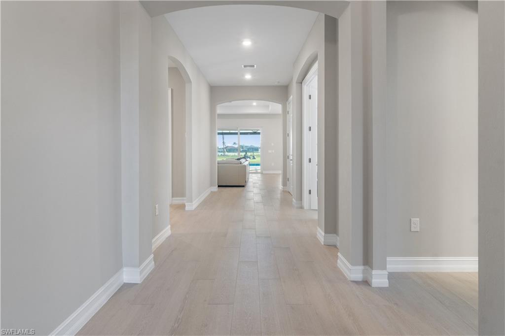 18684 Ensenada Drive Naples, FL 34114 - Photo 11 of 34 a view of a hallway with toilet