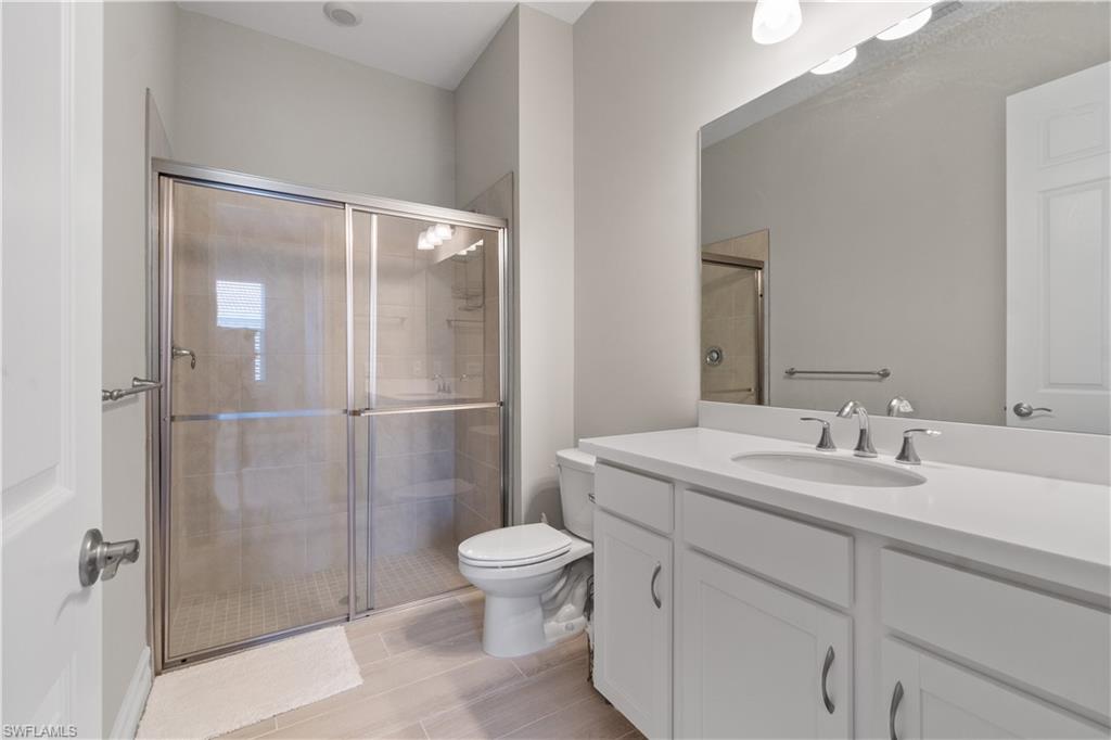 18684 Ensenada Drive Naples, FL 34114 - Photo 21 of 34 a bathroom with a sink toilet and shower