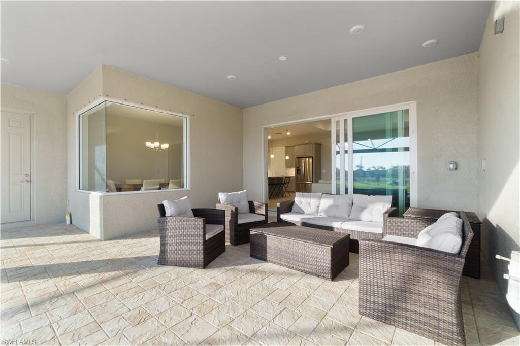 18684 Ensenada Drive Naples, FL 34114 - Photo 26 of 34 a living room with furniture and a large window