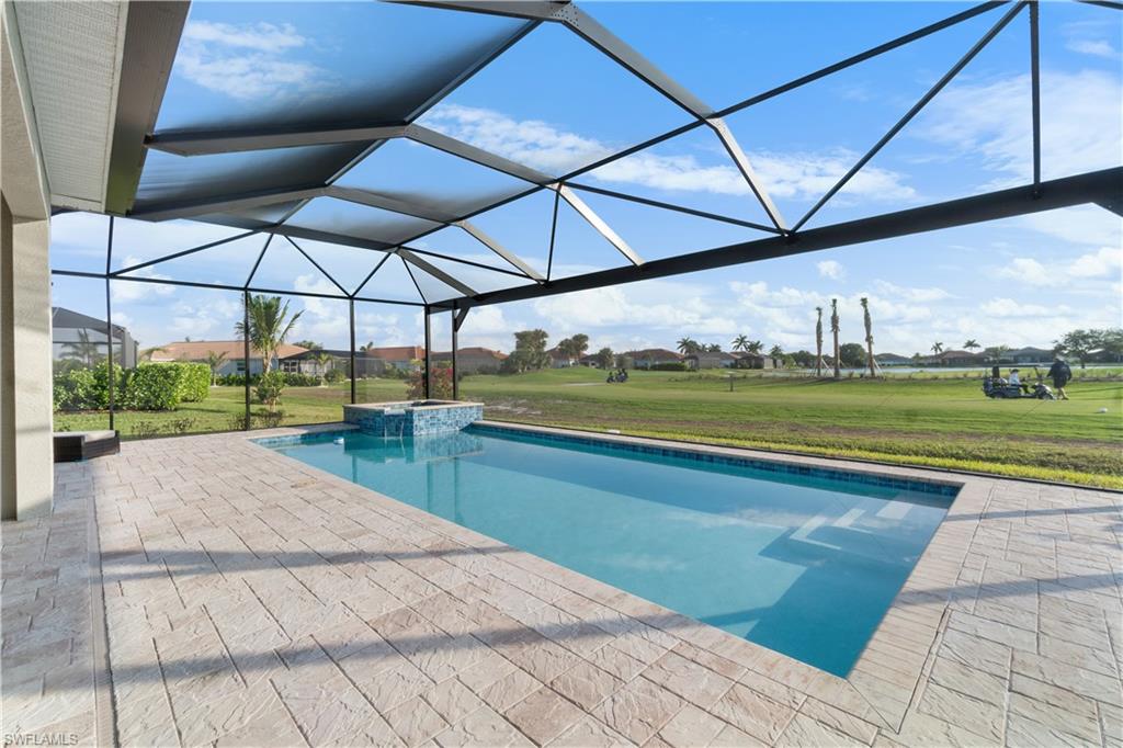 18684 Ensenada Drive Naples, FL 34114 - Photo 27 of 34 a view of a swimming pool with a yard