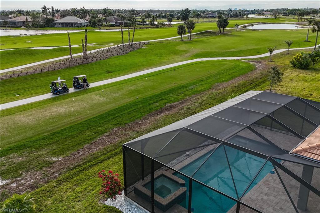 18684 Ensenada Drive Naples, FL 34114 - Photo 33 of 34 a view of a golf course with a lake