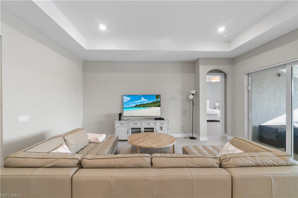 18684 Ensenada Drive Naples, FL 34114 - Photo 5 of 34 a living room with furniture and a flat screen tv