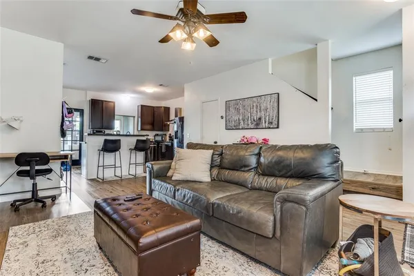 a living room with furniture and kitchen view