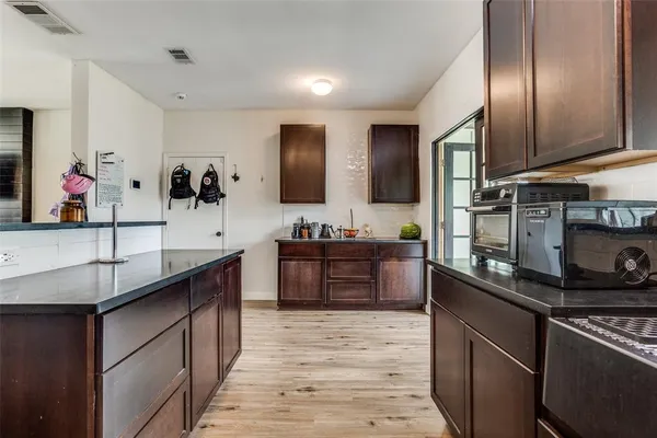 a large kitchen with stainless steel appliances granite countertop a sink stove and refrigerator