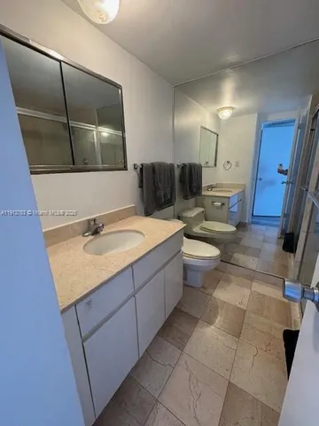 a bathroom with a shower and a sink