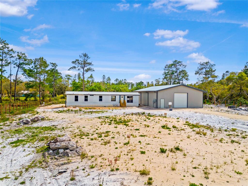 8342 Southwest 152nd Place Dunnellon, FL 34432 - Photo 2 of 96 a large parking space with a tree in the background