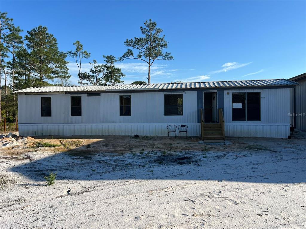 8342 Southwest 152nd Place Dunnellon, FL 34432 - Photo 21 of 96 a front view of a house with a yard