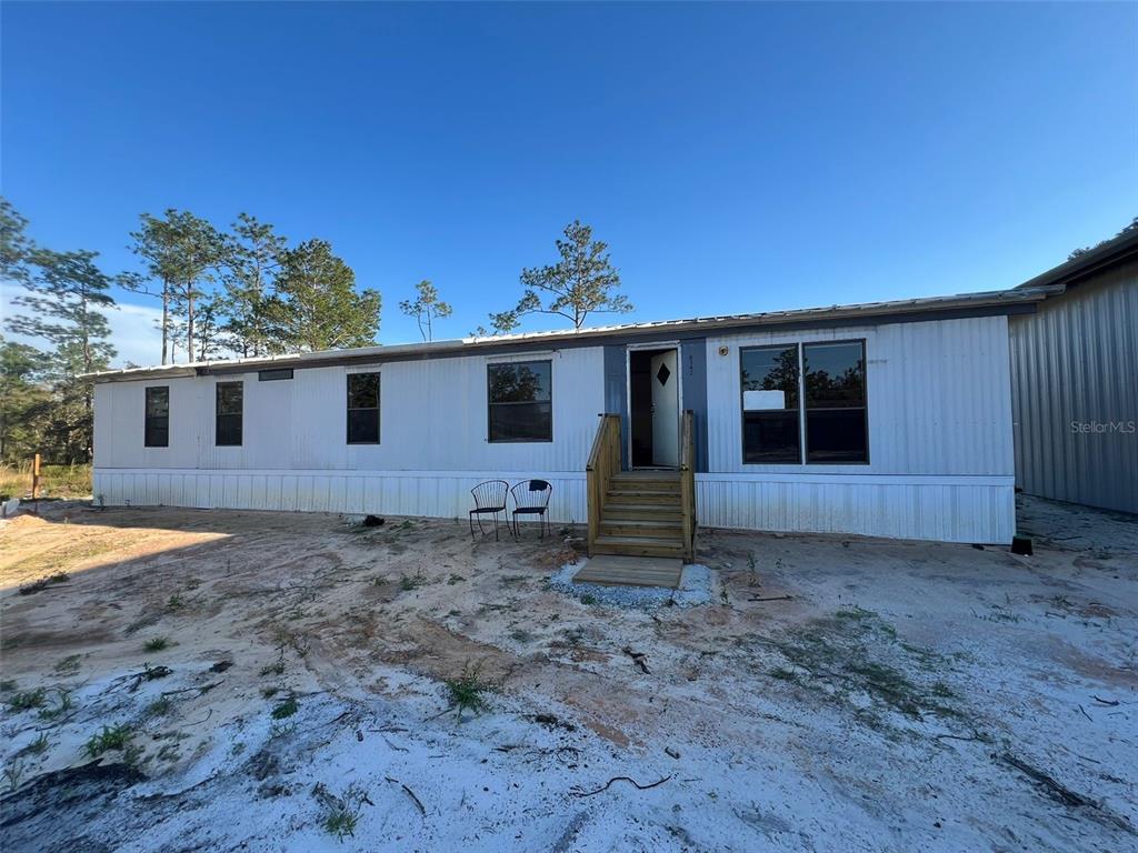 8342 Southwest 152nd Place Dunnellon, FL 34432 - Photo 22 of 96 a view of a house with a backyard
