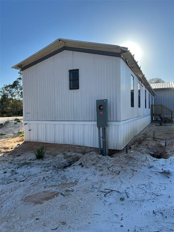8342 Southwest 152nd Place Dunnellon, FL 34432 - Photo 25 of 96 a view of a small white house and a yard