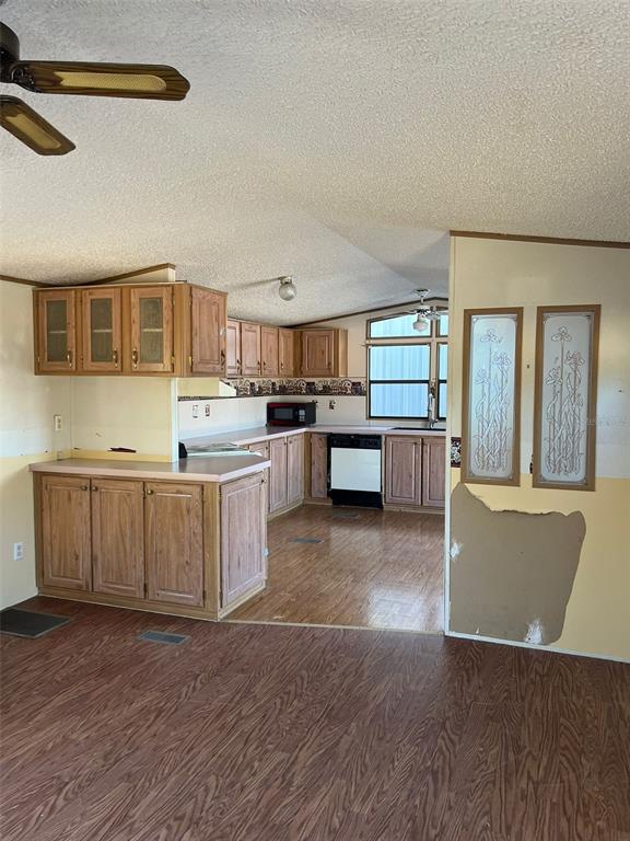 8342 Southwest 152nd Place Dunnellon, FL 34432 - Photo 46 of 96 a kitchen with stainless steel appliances granite countertop a stove top oven a sink dishwasher and a refrigerator with wooden floor