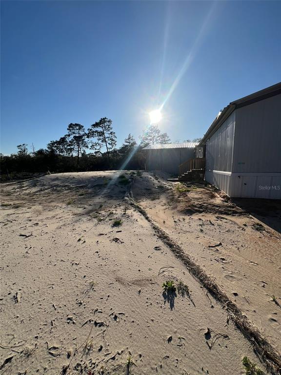 8342 Southwest 152nd Place Dunnellon, FL 34432 - Photo 75 of 96 a view of a dry yard with wooden fence