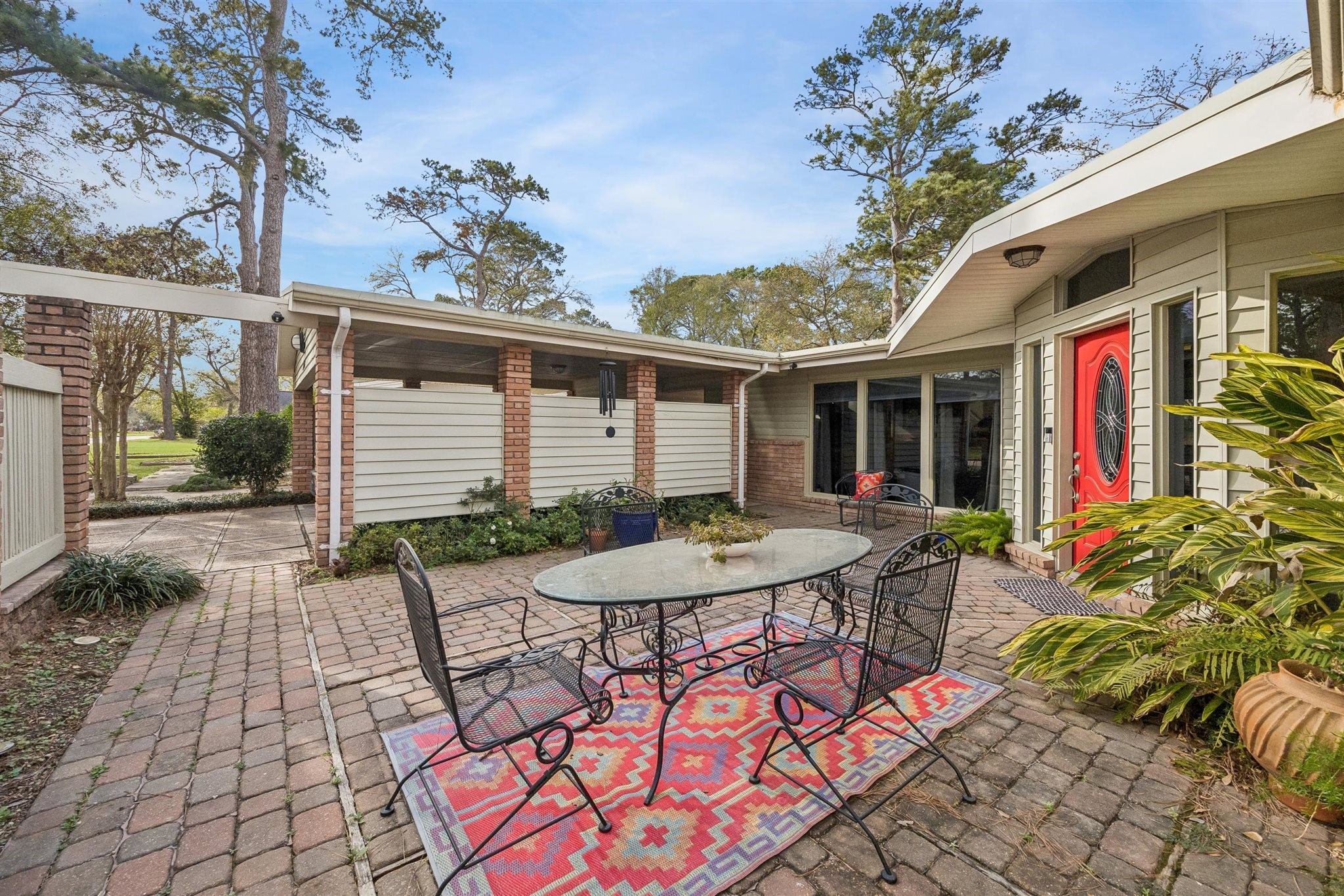 10226 Ivyridge Road Houston, TX 77043 - Photo 25 of 37 a view of a patio with table and chairs and potted plants