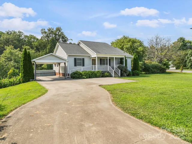 a front view of a house with yard and green space