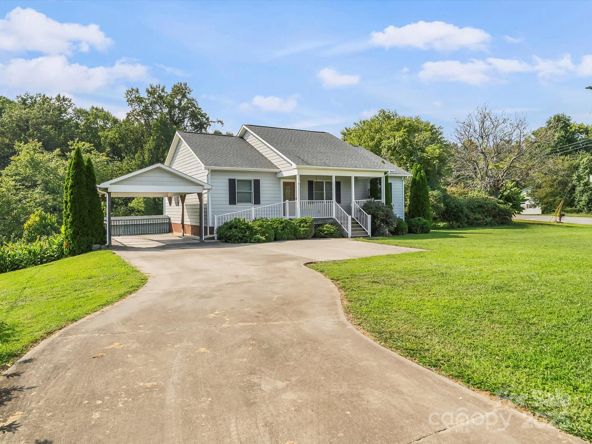 a front view of a house with yard and green space