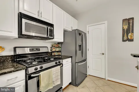 a kitchen with stainless steel appliances a stove a microwave and a refrigerator