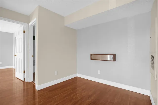 a view of an empty room with wooden floor