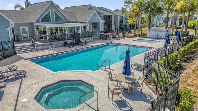 a view of a house with swimming pool and sitting area