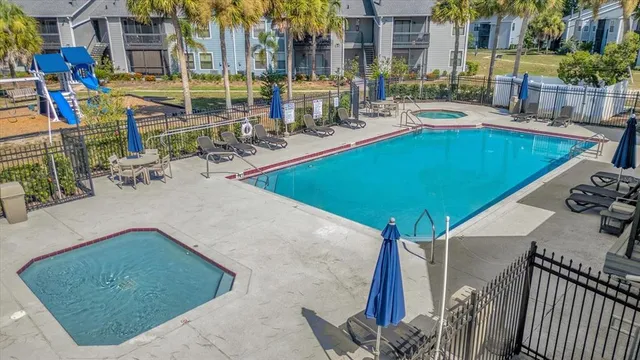 a view of a swimming pool with outdoor seating