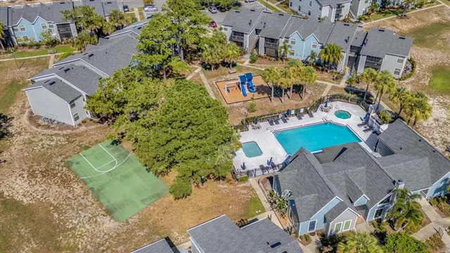 an aerial view of multiple houses with yard