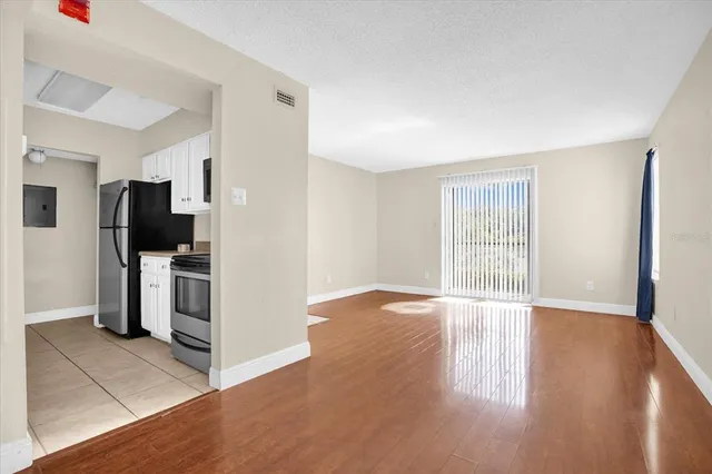 a view of a kitchen with an empty space and a window